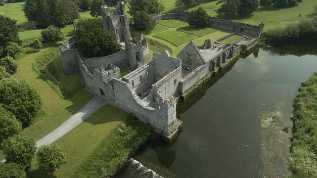 Adare castle ruins beside the peaceful river maigue in county limerick, ireland, aerial view