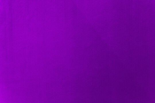 Purple color paint on cement wall texture as background.