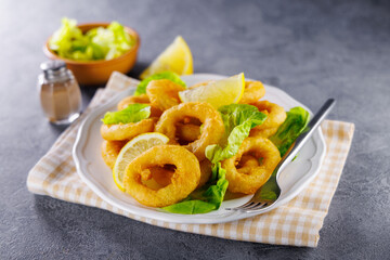 Golden Fried Calamari Rings with Zesty Lemon on a Plate