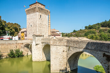 Obraz premium View at the Ancient Tower and Roman bridge over Metauro river in Fermignano, Italy