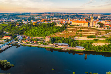 Melnik Castle on the hill above Labe and Vltava River in sunny day.  Church with city space and square. Czech Republic.
