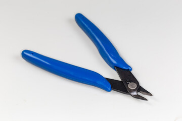 Fototapeta premium Diagonal nippers with blue insulated handles on a gray background