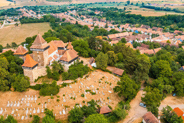 Obraz premium Viscri, Romania. Blue old painted traditional house from village, Transylvania. The Viscri fortified church