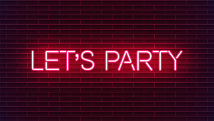 Neon sign with let's party message on red brick wall