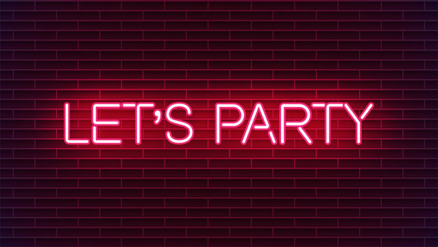 Neon sign with let's party message on red brick wall