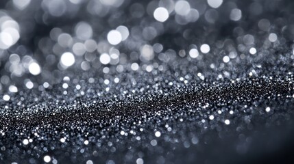 A mesmerizing close-up of shimmering black and silver glitter sparkles, creating a magical atmosphere.