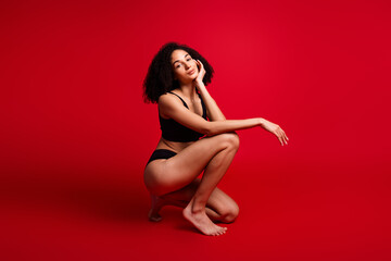 Full length photo of lovely young lady squat enjoy bodycare dressed black lingerie no filter...