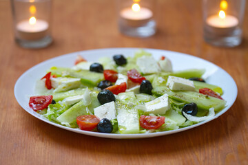 Greek salad with feta cheese and black olives, salad with cucumber, tomatoes, olive oil, olives, feta cheese