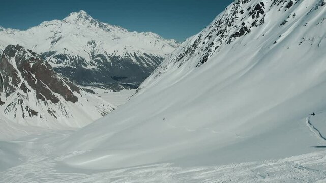 Freeride snowboarding in winter. Heliboarding freeride. Riding in powder on snowborad. Ski, Snowboard freeride i deep powder snow. Gudauri Georgia Caucasus resort. Freeride in Caucasus mountains. 