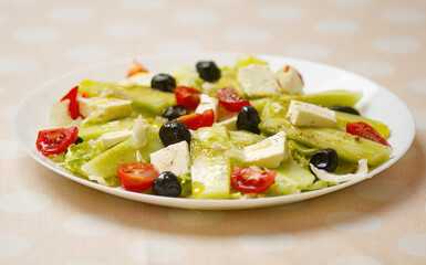 Greek salad with feta cheese and black olives, salad with cucumber, tomatoes, olive oil, olives, feta cheese