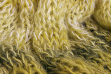 Gradient knitted background. Lemon coloured alpaca and wool threads with beautiful knitting pattern. Gradient crochet in warm colours. Knitting hobby. Knitwear concept. Needlework background.
