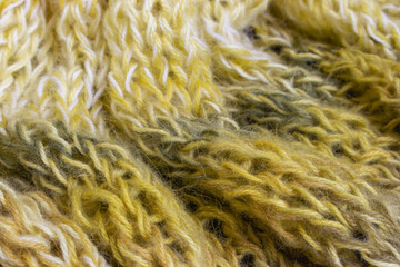 Gradient knitted background. Lemon coloured alpaca and wool threads with beautiful knitting pattern. Gradient crochet in warm colours. Knitting hobby. Knitwear concept. Needlework background.
