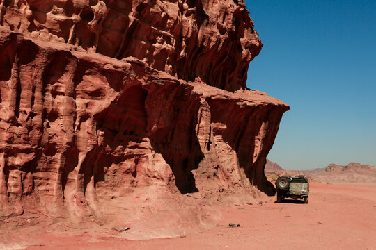 Exploring the stunning rock formations and terrain of Wadi Rum Desert during a clear sunny day in Jordan