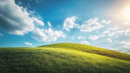 Obraz premium A rolling green hillside under a bright sky with scattered clouds, symbolizing freedom and open possibilities