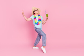 Full size photo of pretty aged woman drink cocktail dancing isolated on pink color background