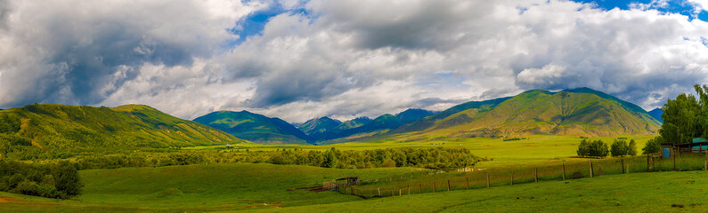 wide panorama of Semenovskoye gorge in Kyrgyzstan at cloudy summer day.