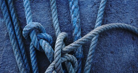 knots in industrial ropes on cement