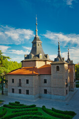 Fototapeta premium Vertical photograph of the Hermitage of the Virgen del Puerto, in Madrid, Spain, with a very cloudy sky in the background.