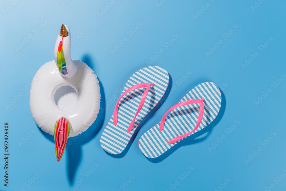 Poster a vibrant summer vacation scene with flip flops and a floating flamingo