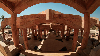 Exploring the ancient architecture of Nature Jordan under the clear blue sky with intricate stone structures and shadow patterns
