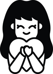 A girl is holding a heart and smiling