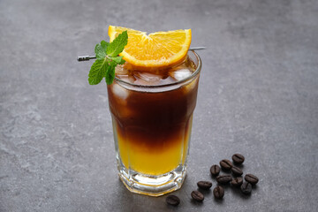 Iced americano black coffee and layer of orange juice  
