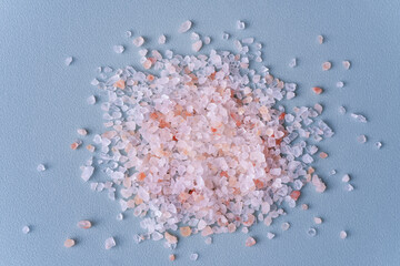 Pink Himalayan Salt on blue background. Cooking, bathing, teeth cleaning, spa therapy. Top view. 