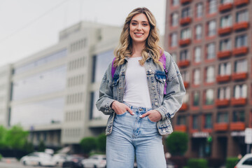Photo of nice young woman put arms pockets posing backpack wear denim jacket walk city center...
