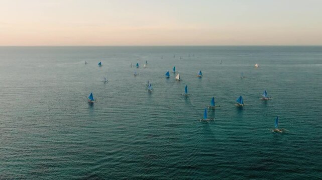 Beautiful view of paraw sailing boats over the sea. Tropical Beach in Boracay Island. Philippines.