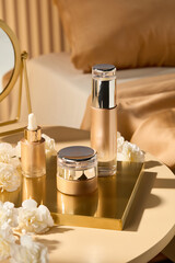 Advertising image shown by luxurious skincare set is displayed on a golden tray placed on a light...
