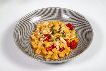 Gnocchi hand made with fresh fish and cherry tomatoes in an elegant dish