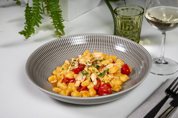 Gnocchi hand made with fresh fish and cherry tomatoes in an elegant dish
