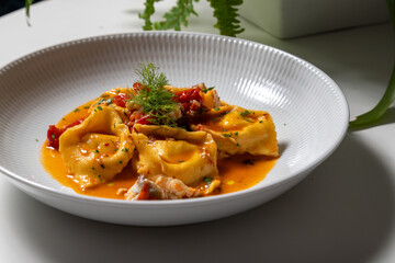 Tortellini with fresh fish sauce. This typical Italian pasta is also called tortelloni or cappellacci