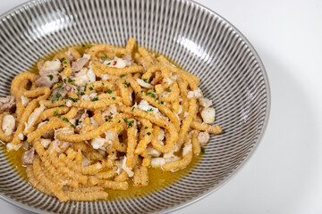 Passatelli with fish, typical Italian homemade pasta. Handmade Passatelli with fresh fish sauce