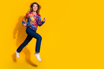 Photo portrait of young happy blonde sweet girl hurry up running fast jumping starting sales season isolated on yellow color background