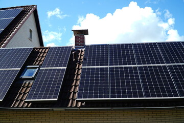 Photovoltaic installation where the glistening bright sun is reflected on the black solar panels....