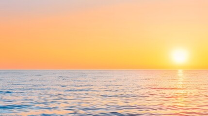 Obraz premium Dramatic golden hues paint the sky as the sun dips below the horizon, casting long shadows across the shimmering ocean