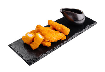 Deep fried breaded chicken fingers with dipping sauce on black slate platter