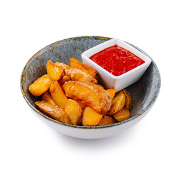 Bowl of potato wedges with tomato sauce and a rustic background