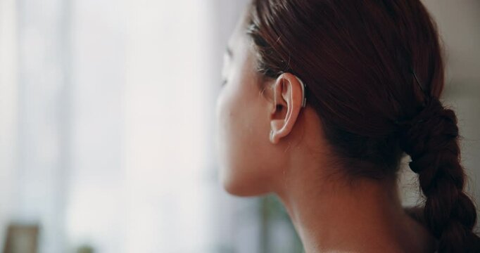 Woman, ear and hearing aid for person with a disability, listening and communication with sound waves. Female patient, deaf and audio technology for healthcare, treatment or amplifier with microphone