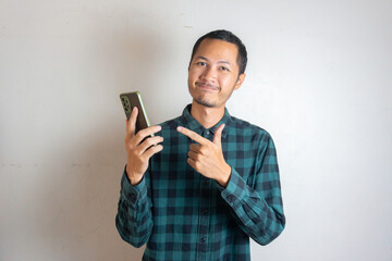 Young asian men is holding smartphone with happy expression in isolated white background