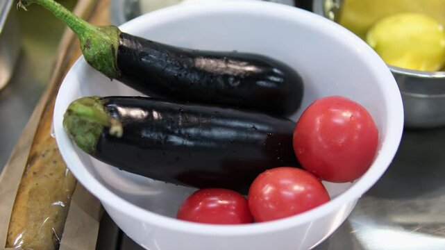 tomatoes and eggplants Chinese eggplant zucchini and tomatoes fried on the BBQ grill. Vegetarian or vegan dish fried cooking vegetables on fire barbecue. Fresh organic eggplants from community 