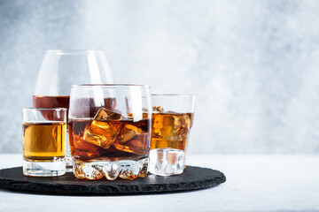Strong alcohol drink set at light background. Cognac, whisky, tequila and rum.