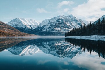 Fototapeta premium A serene mountain landscape reflecting in calm waters under a clear blue sky.
