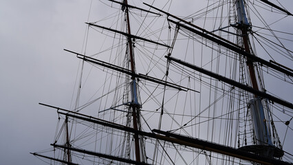 Fototapeta premium Braces, shkots, halyards on a sailing ship, sky backdrop, maritime ropes theme