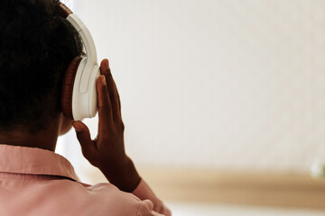 Young woman listening music with headphones at home