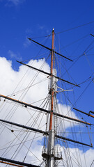 Fototapeta premium Halyards, shkots, and braces on sailing vessel, blue sky, shipbuilding theme.