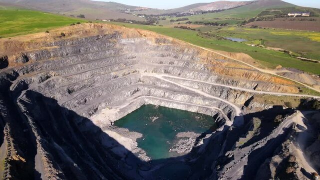 Deep quarry shows concentric digging rings, South African mining industry. Drone