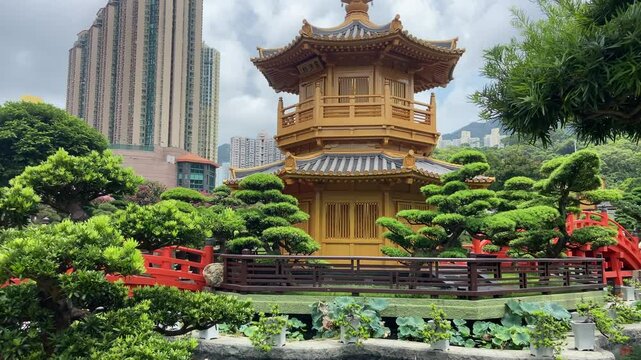 Pond and pagoda in Chinese Nan Liam park in Hong Kong. Tilt up