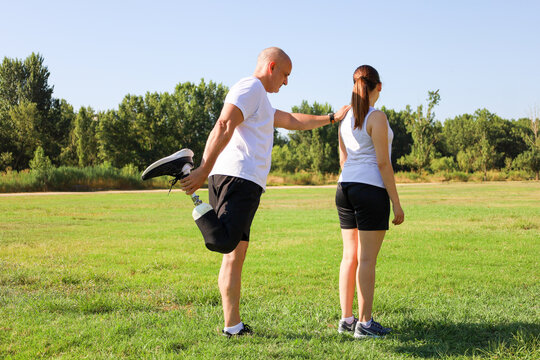 Father with prosthetic leg spending time with daughter outdoors